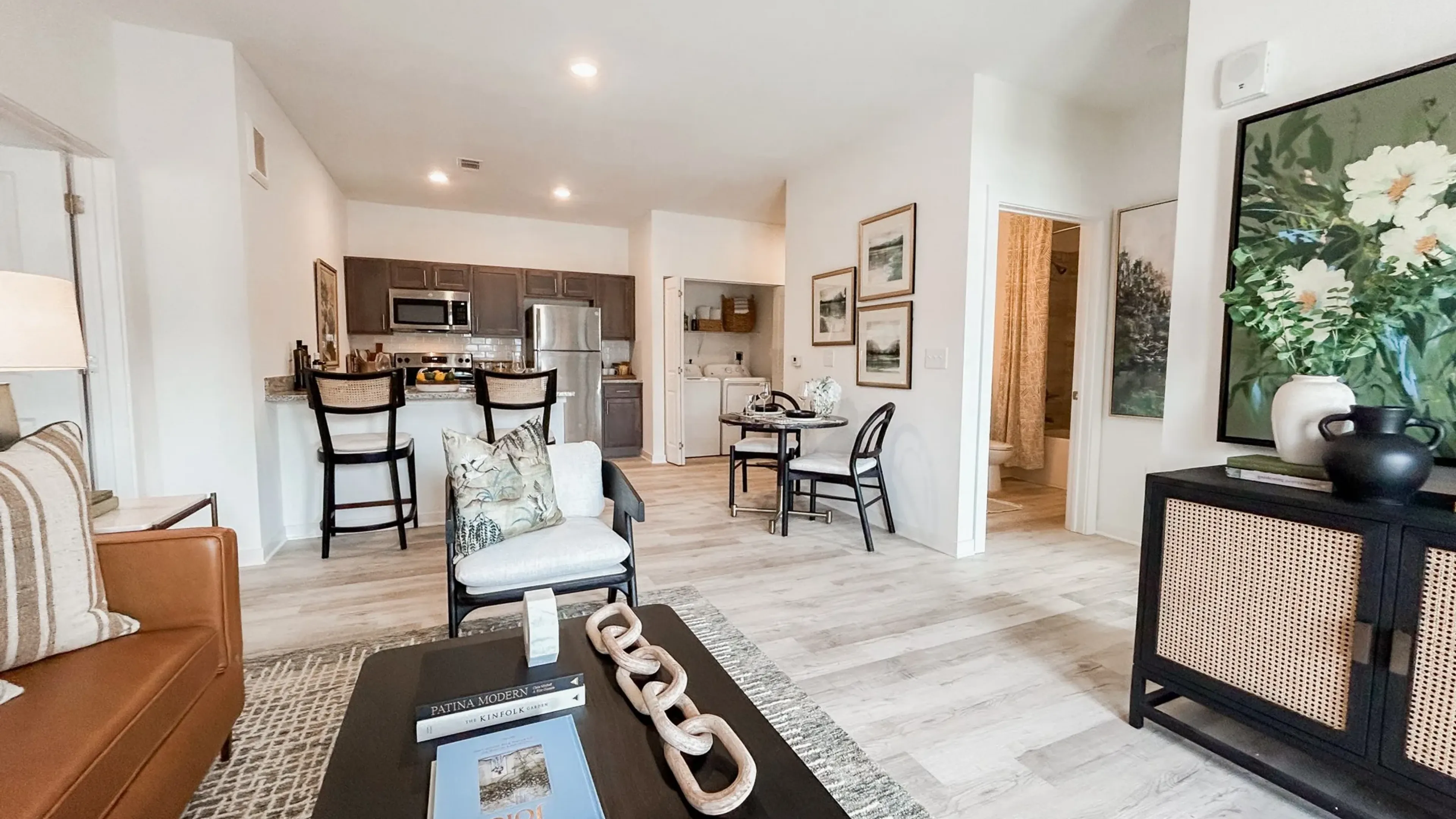 The Austin Apartment Homes apartment living and kitchen area with stainless steel appliances and natural light