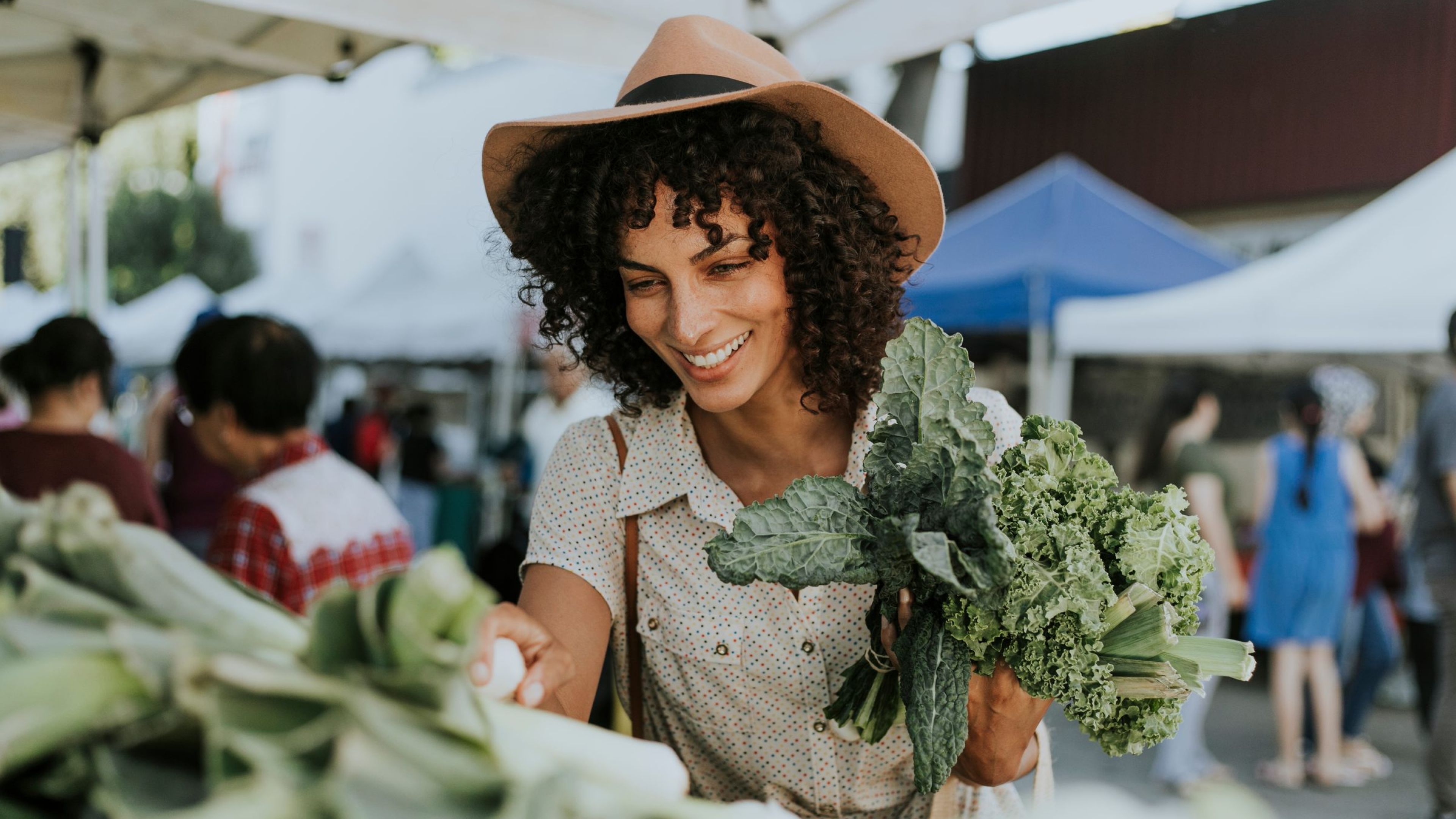 The Austin Apartment HomesThe Austin Apartment Homes Beautiful woman buying kale at a farmers market