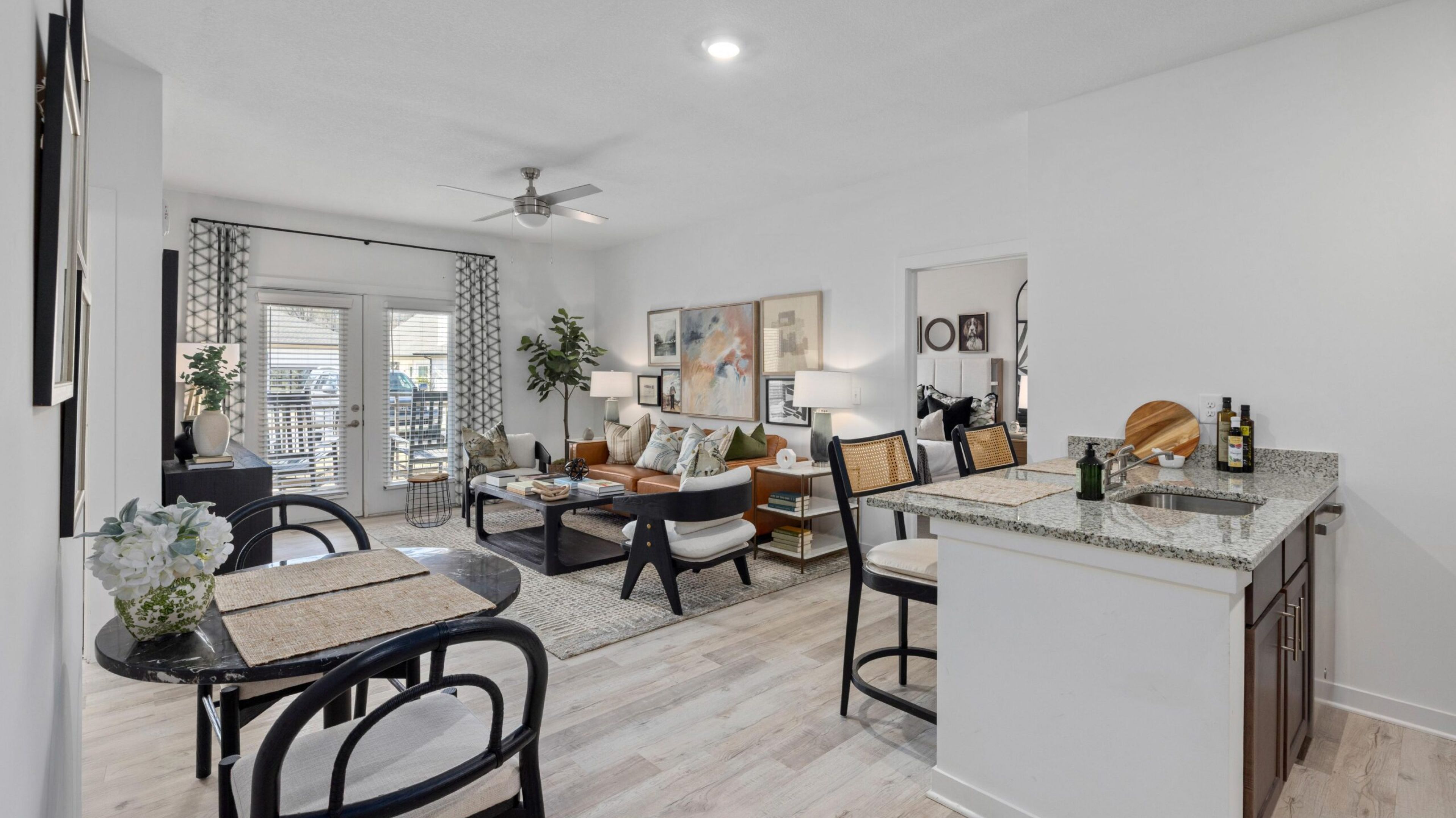 The Austin Apartment Homes apartment living and kitchen area with stainless steel appliances and natural light