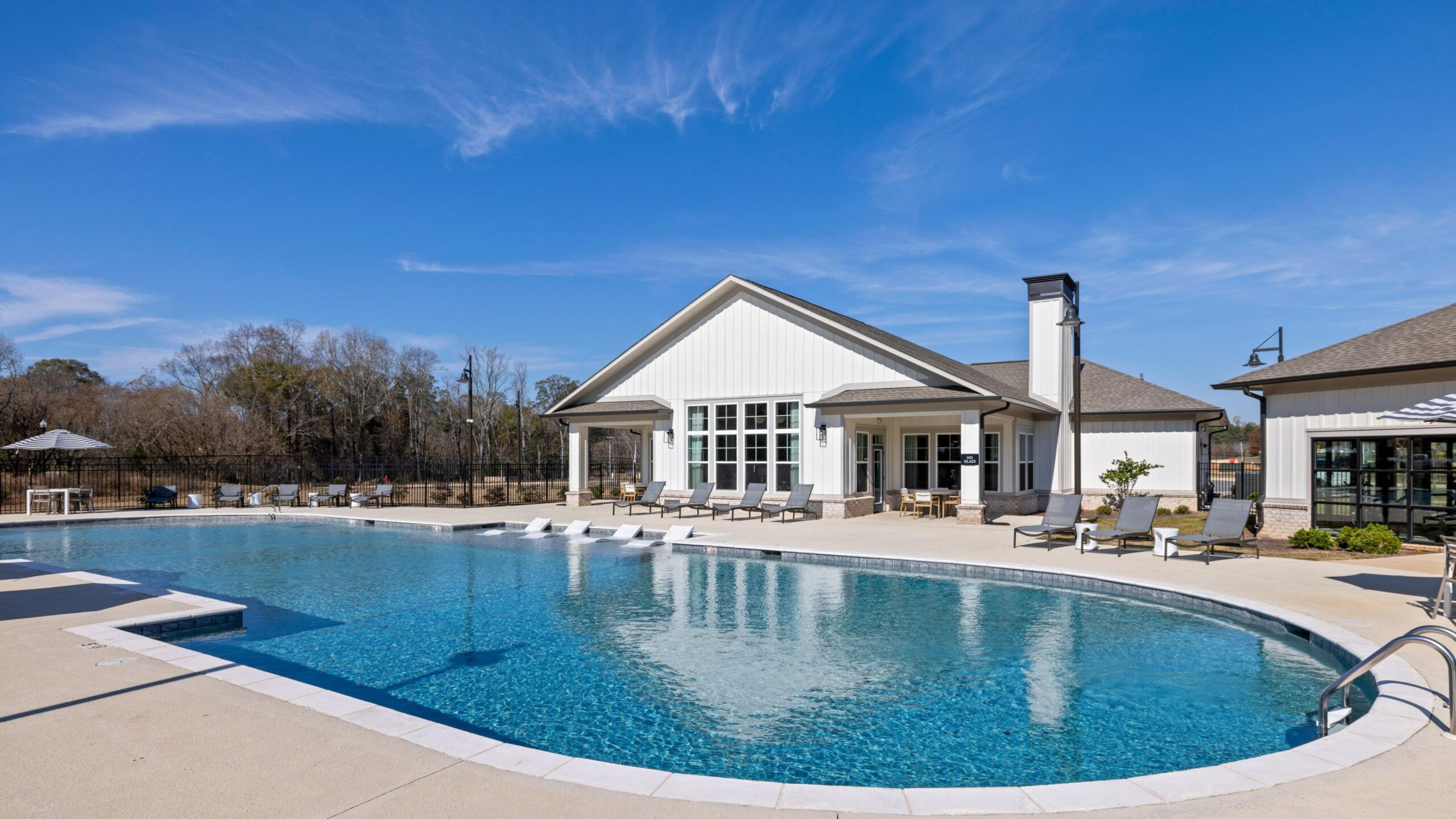 The Austin Apartment HomesThe Austin Apartment Homes Smiling young man relaxing at home and using tablet